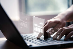 employee typing on laptop